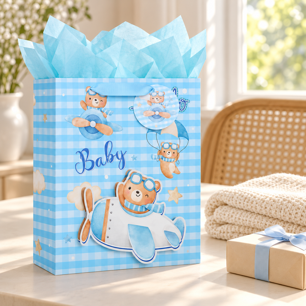 Blue baby gift bag in a gift preparation setting; blanket and gift box are styling props.