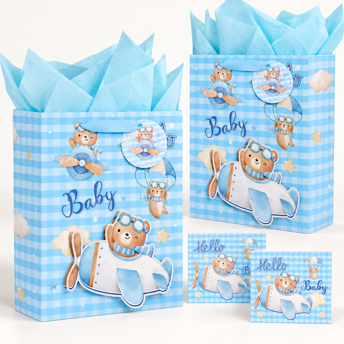 Two blue baby gift bags with matching round tags, cyan tissue and Hello Baby greeting cards.