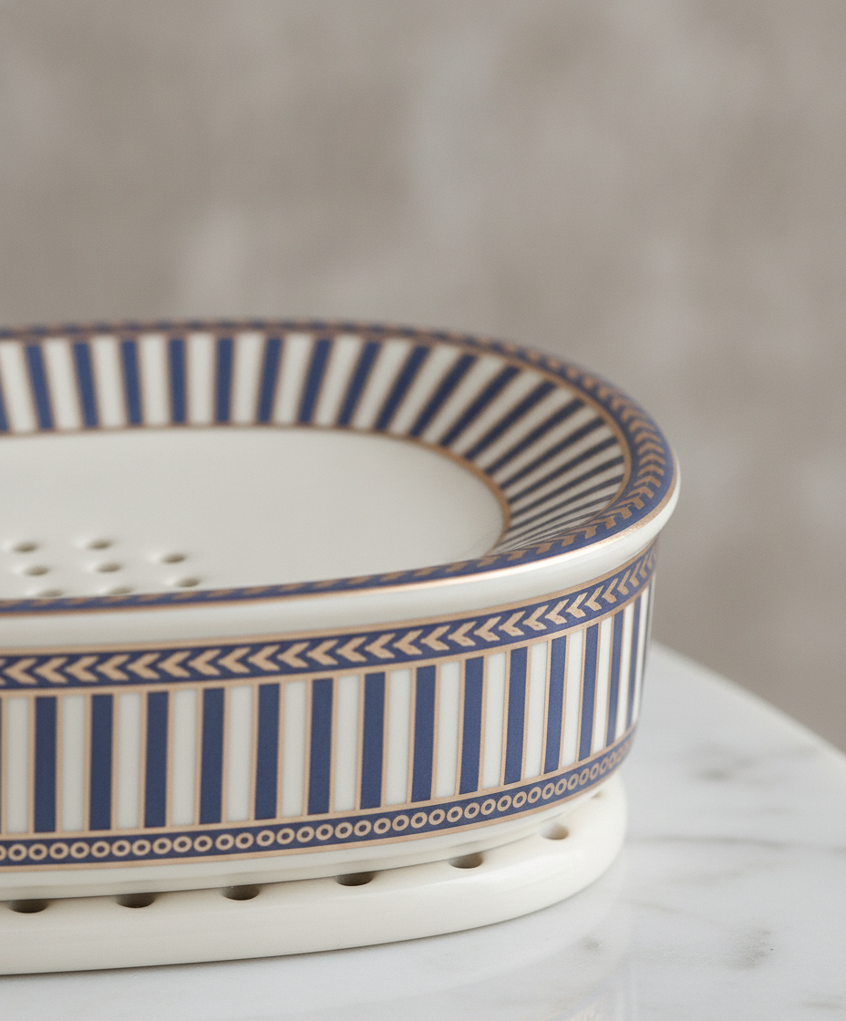 Macro detail of the patterned rim band and glazed ceramic of the soap dish
