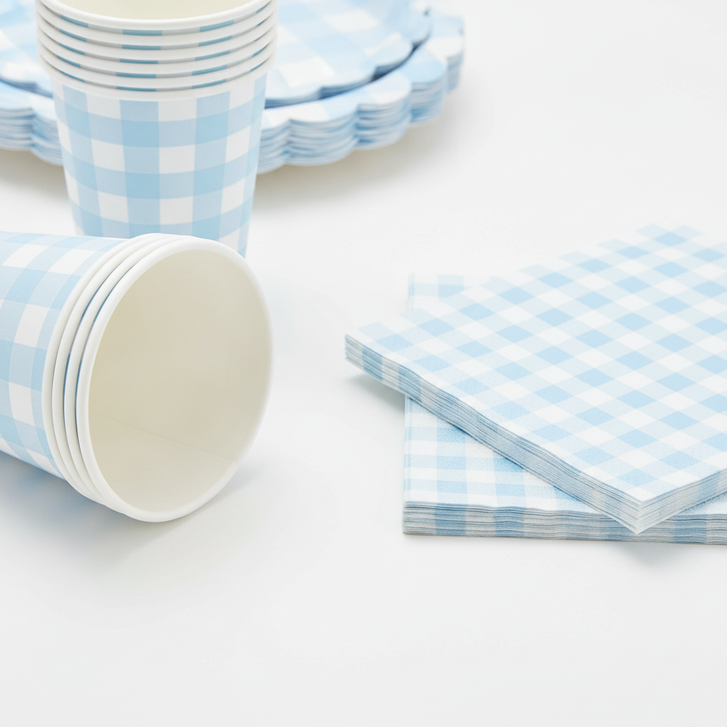 Stacked blue gingham paper cups and scalloped napkins detail
