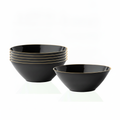 Stack of black gold-rim disposable plastic party bowls on white background