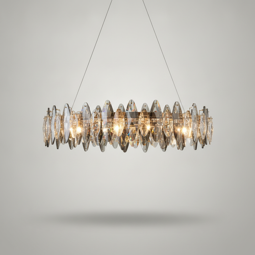 Cascade crystal LED chandelier glowing warm on a soft grey studio backdrop