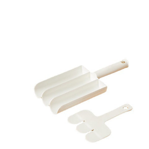 White three-channel meatball scoop and three-prong paddle on a white background