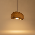 Nimbus wabi-sabi cloud pendant lamp glowing warm on a soft beige studio backdrop