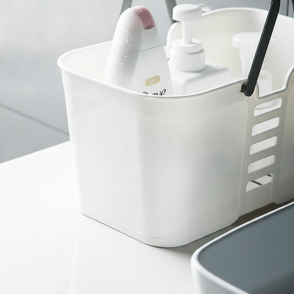 Close-up of the slotted drainage side panel and grey carry handle of the shower caddy