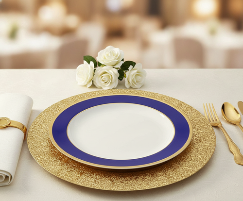 Blue and gold rim plate on a gold charger in an elegant place setting
