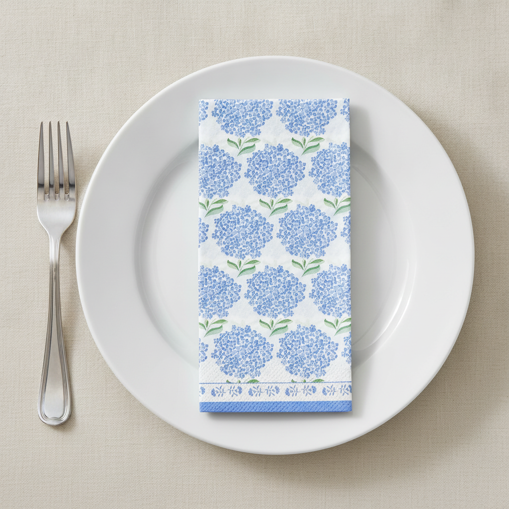 Hydrangea floral paper napkin folded on a plain white plate place setting