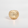 Merletto gold lace orb candle holder with glowing tealight on white