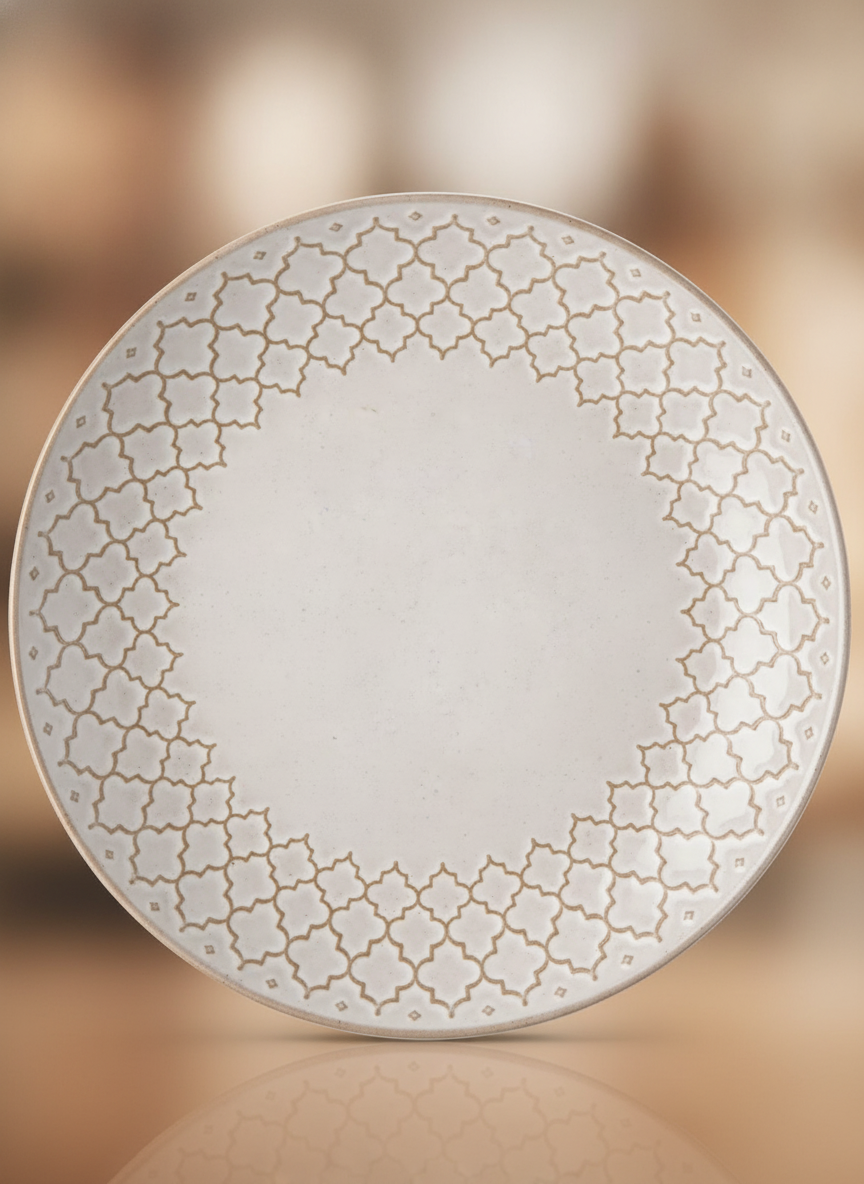 Close-up of the Moroccan quatrefoil lattice relief and antique tan glaze on a Marrakech plate