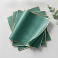Angled fanned stack of teal green gold-edge floral wrapping sheets