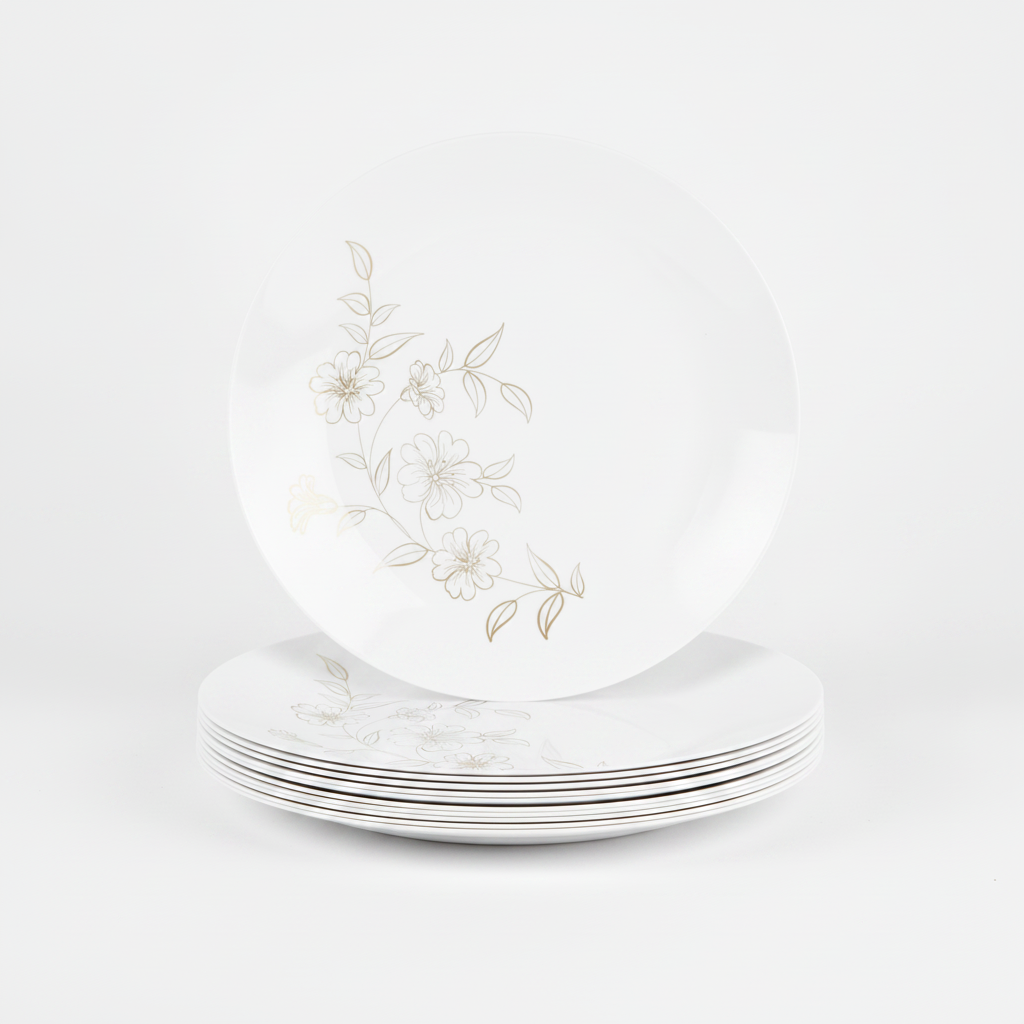 Stack of white plastic plates with gold floral line design on white background