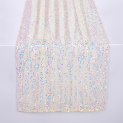Iridescent champagne sequin table runner draped on a soft-white studio surface, sparkling 5mm sequins catching the light