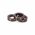 Octagonal bronze metal napkin rings, set of 12, on white background