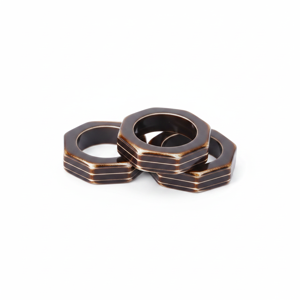 Octagonal bronze metal napkin rings, set of 12, on white background