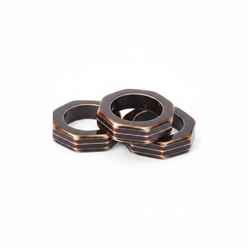 Octagonal bronze metal napkin rings, set of 12, on white background