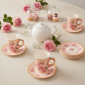 Romantic styled tea party table with blush bird and rose disposable paper cups and saucers