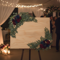 Navy and burgundy floral swags on a wooden wedding welcome sign