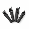 Pre-rolled black plastic cutlery wrapped in black napkins fanned on white