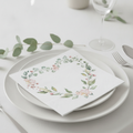 Floral botanical wedding paper napkin folded on a plate at an elegant place setting