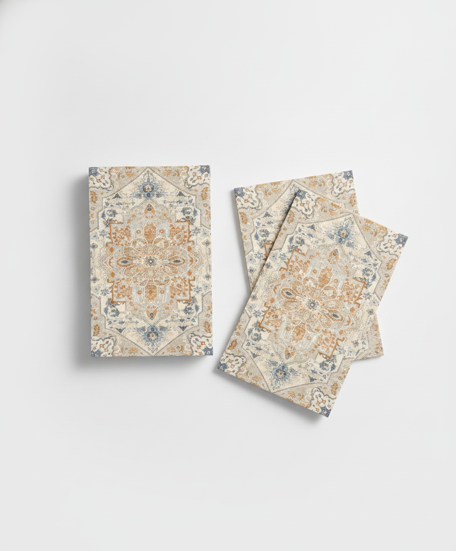 Stack of rectangular boho orange and cyan paper guest napkins fanned on a white background