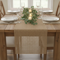 Natural burlap runner styled down a rustic farmhouse dining table with florals and candles