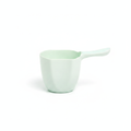 Mint green kids bath rinse cup scooper with curved handle and pour spout on white background