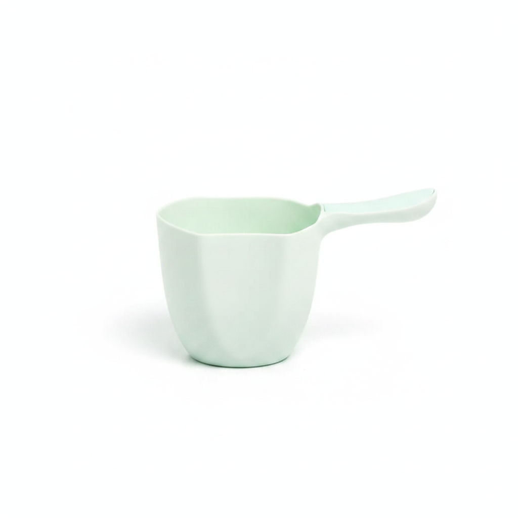 Mint green kids bath rinse cup scooper with curved handle and pour spout on white background