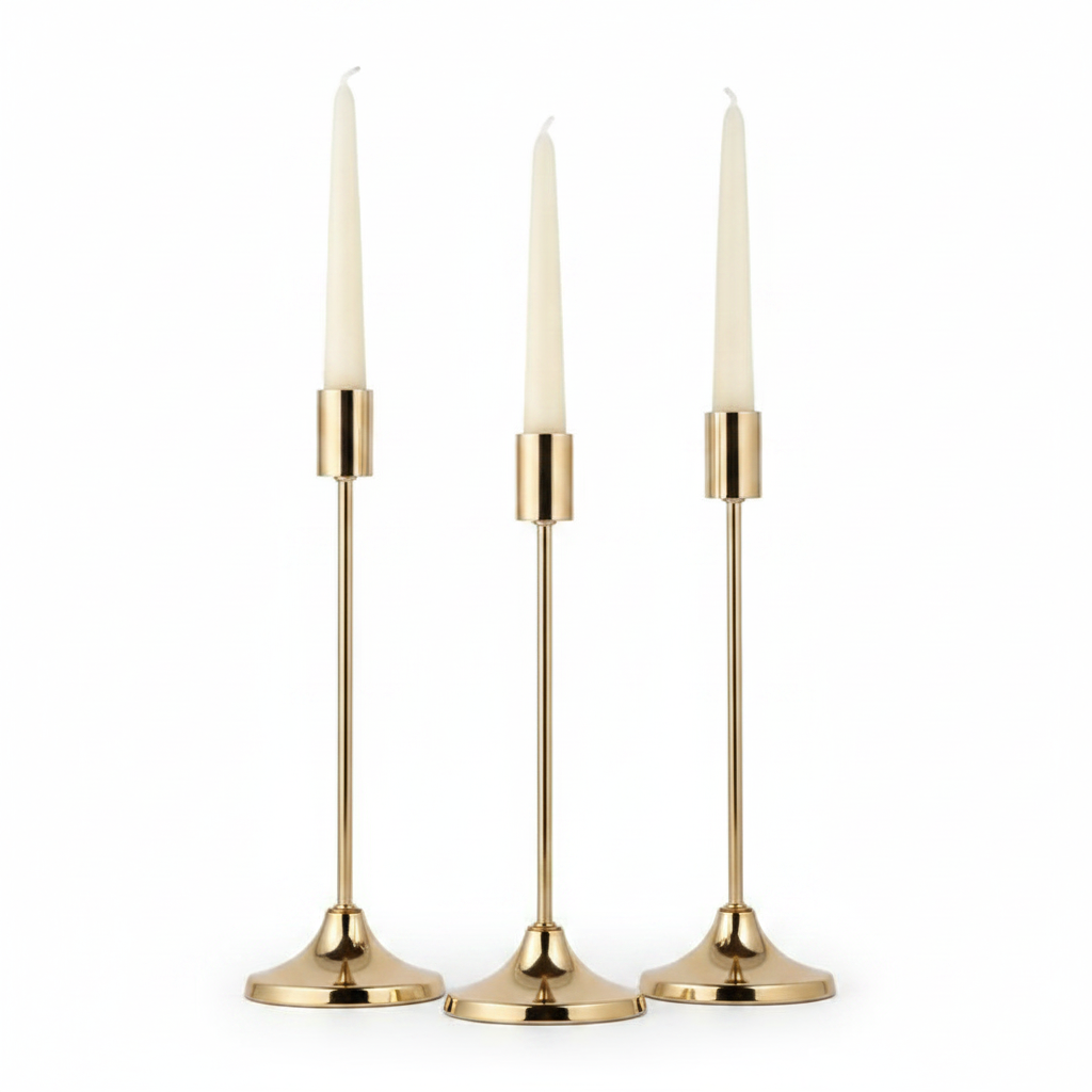 Nozze set of three graduated gold taper candlestick holders with ivory candles on white