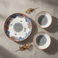 Overhead flat-lay of butterfly floral underglaze ceramic plate and bowl set
