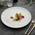 Martellato plate with restaurant-plated dish on a slate table, fine-dining setting