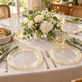 Clear 10-inch gold-trimmed plastic plates at four coordinated place settings with ivory linen, sage napkins and white flowers. Food and styling props not included.