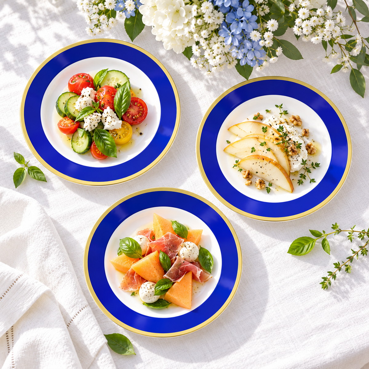 Overhead view of three small blue and gold plates holding cold appetizer portions on white linen. Representative arrangement; food and styling props not included.