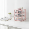Clear plastic drawer organizer on a tidy desk holding stationery
