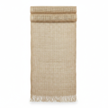 Natural jute burlap table runner draped on a white background showing the open weave and frayed fringe