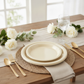 Ivory disposable plastic plates table place setting — round ivory plates with textured rim, gold flatware, glass goblet