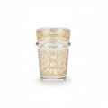Zellige gold-filigree Moroccan tea glass with intricate gold lacework on a white background
