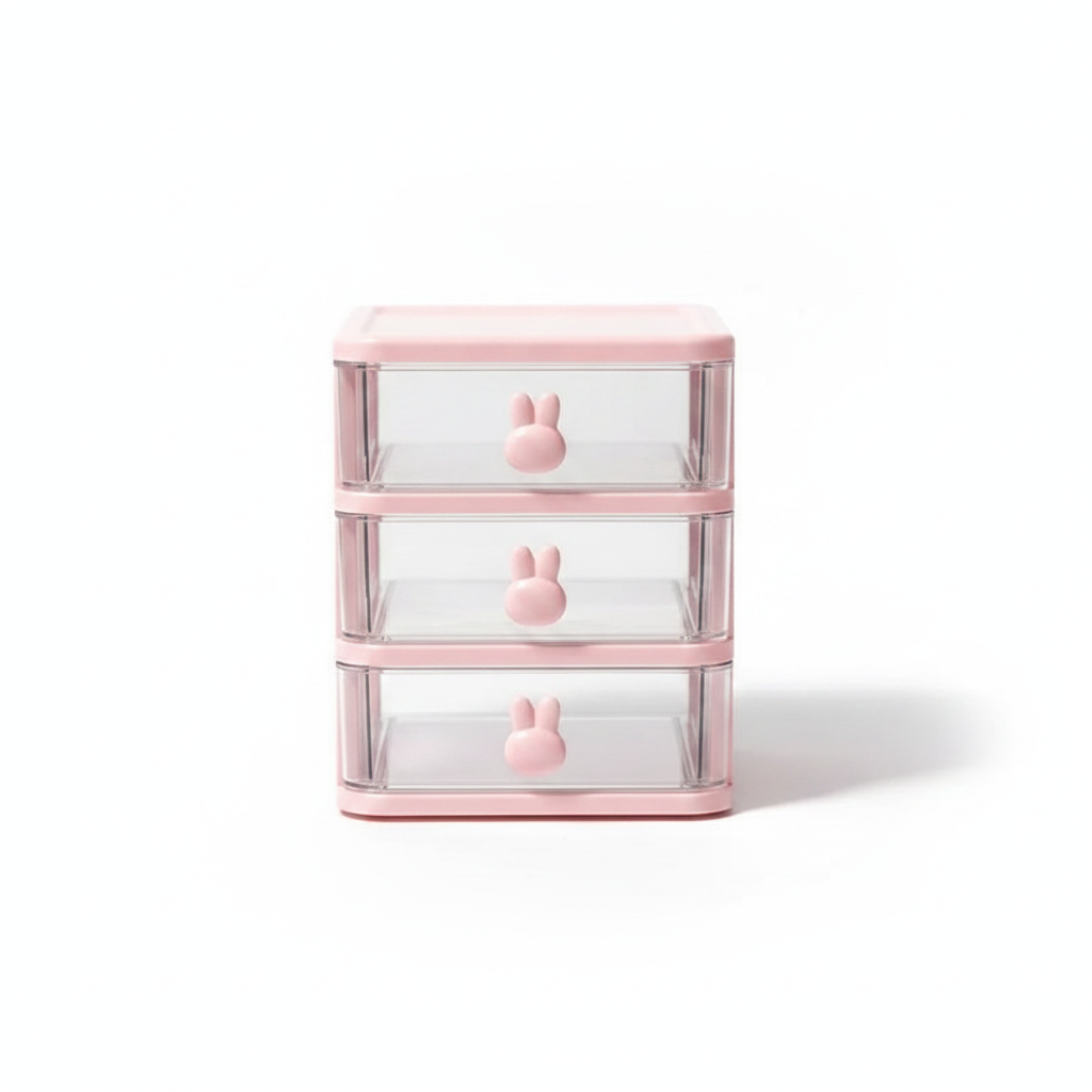 Clear plastic multi-layer desk drawer organizer with rabbit knobs on white background