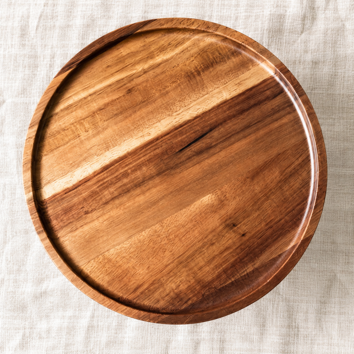 Top view of the acacia wood dessert stand showing the raised rim and natural grain