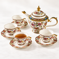 Clean full floral tea set with teapot and four cups and saucers