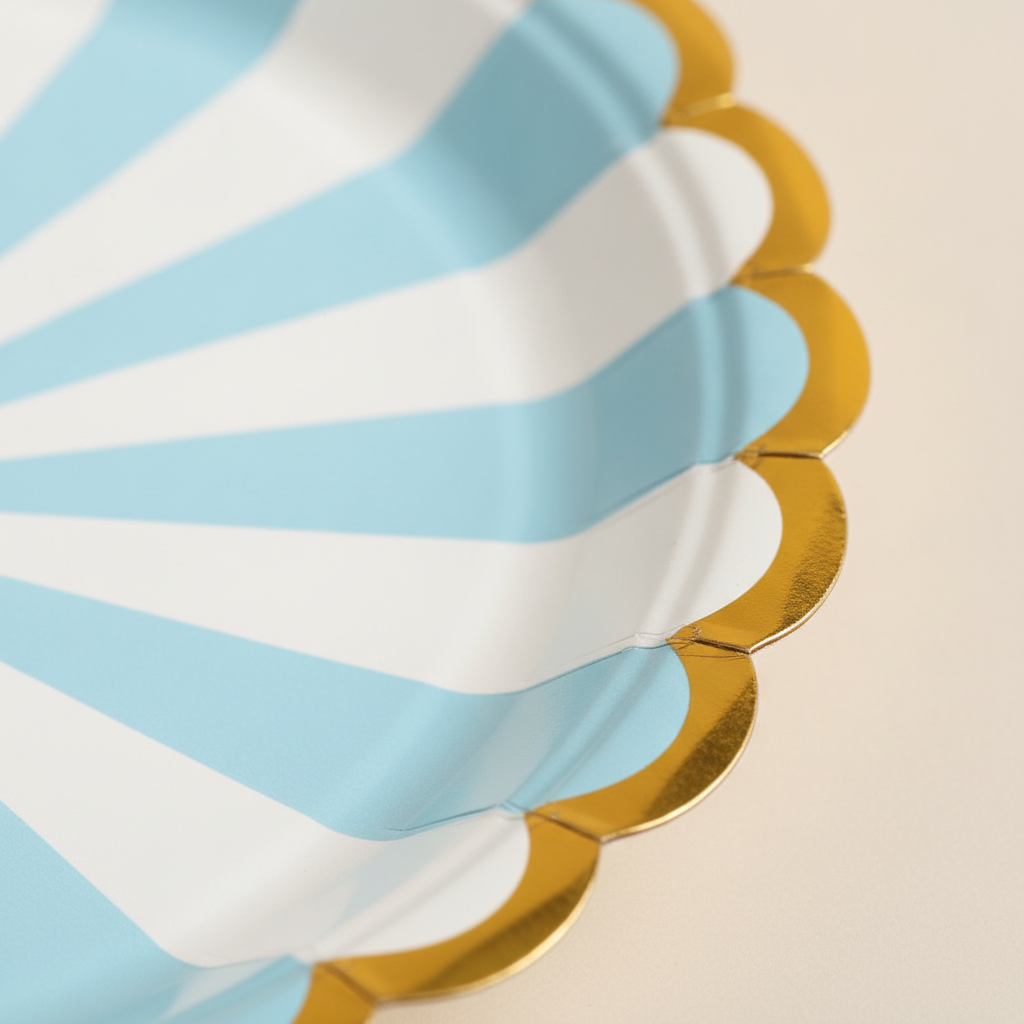Macro close-up of blue striped scalloped paper plate with gold foil rim