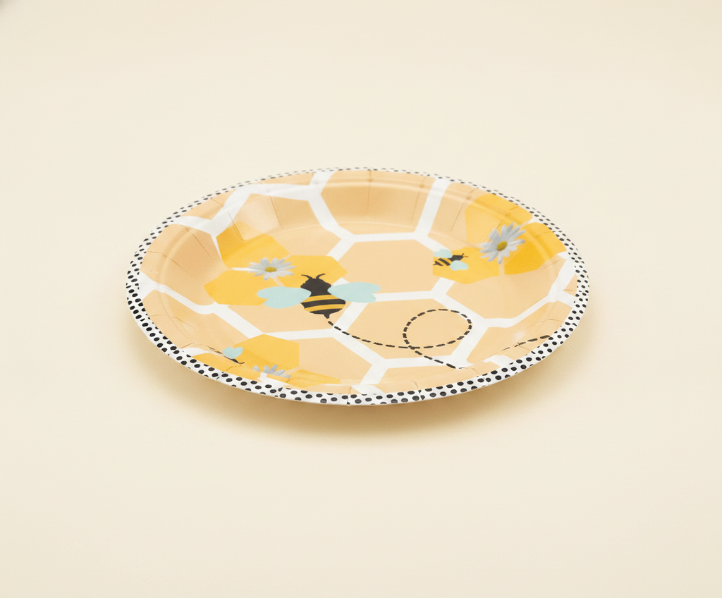 Single bee-design disposable paper party plate showing honeycomb and bumblebee print