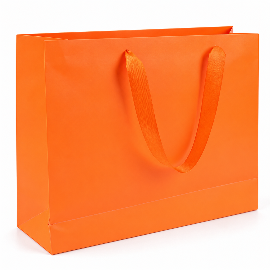 Plain orange gift bag with matching ribbon handle on white background