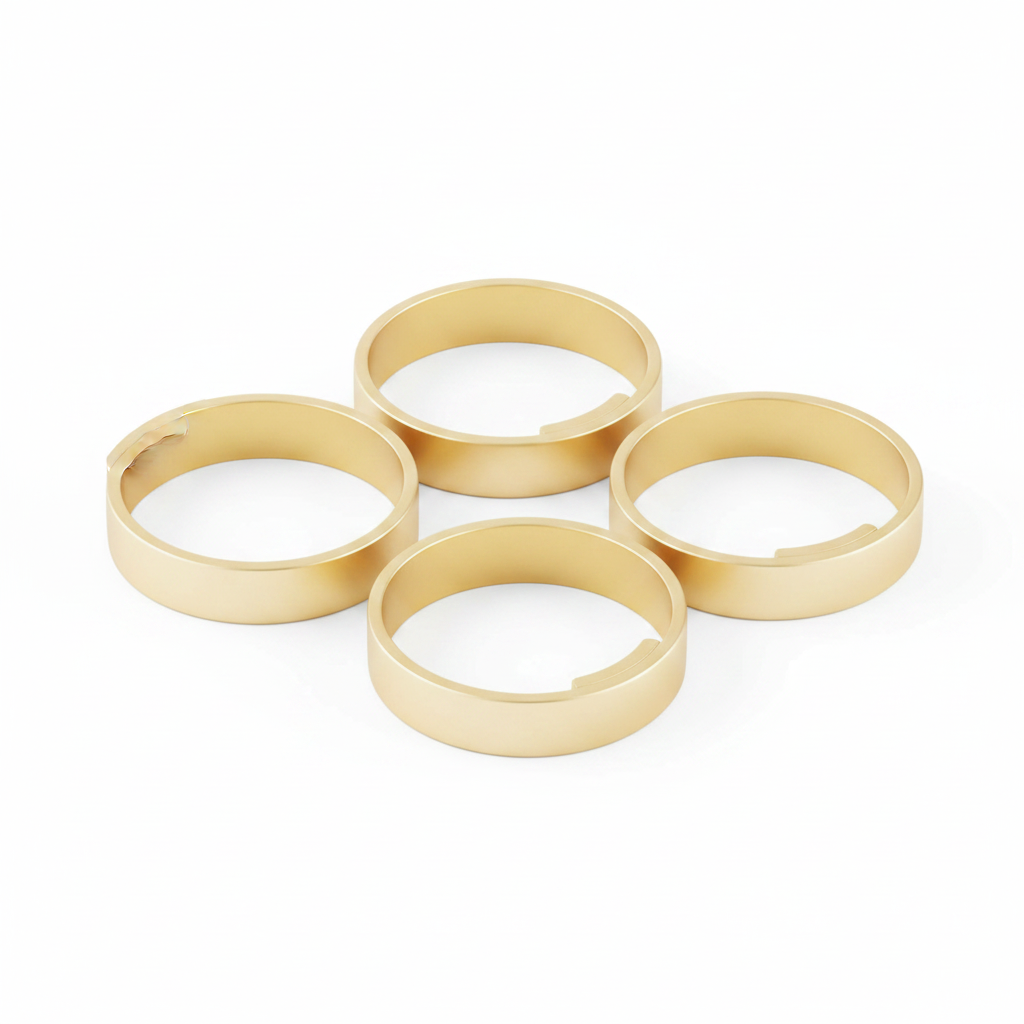 Plain gold metal round napkin rings, set of 6, on white background