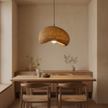 Cloud pendant glowing above a wooden dining nook in a serene Japandi interior