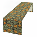 Sage green burlap table runner with orange vintage floral print, full length draped on white