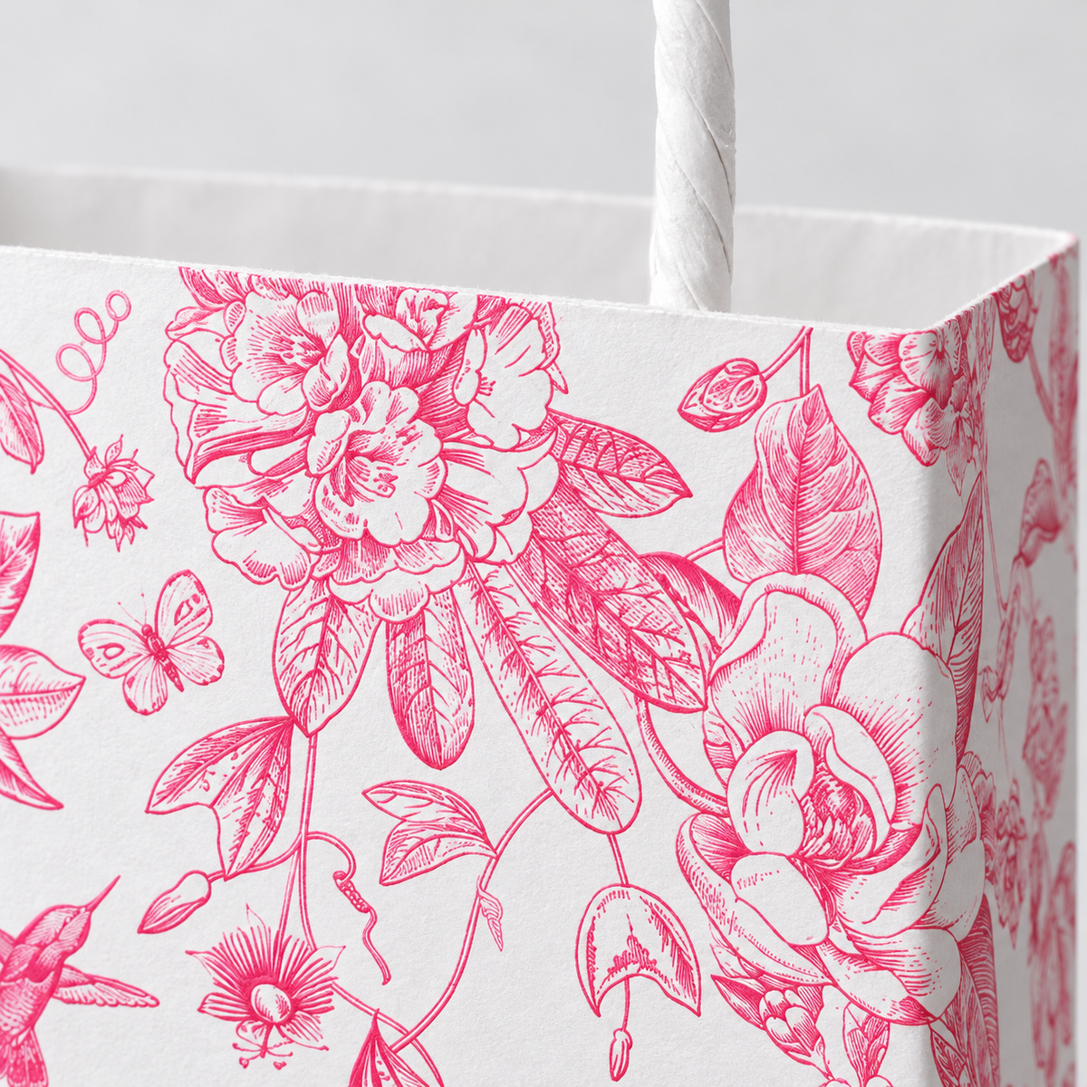 Pink floral gift bag paper texture and twisted paper handle detail