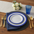 Dark blue rim disposable plastic dinnerware place setting with clear blue cup and gold flatware