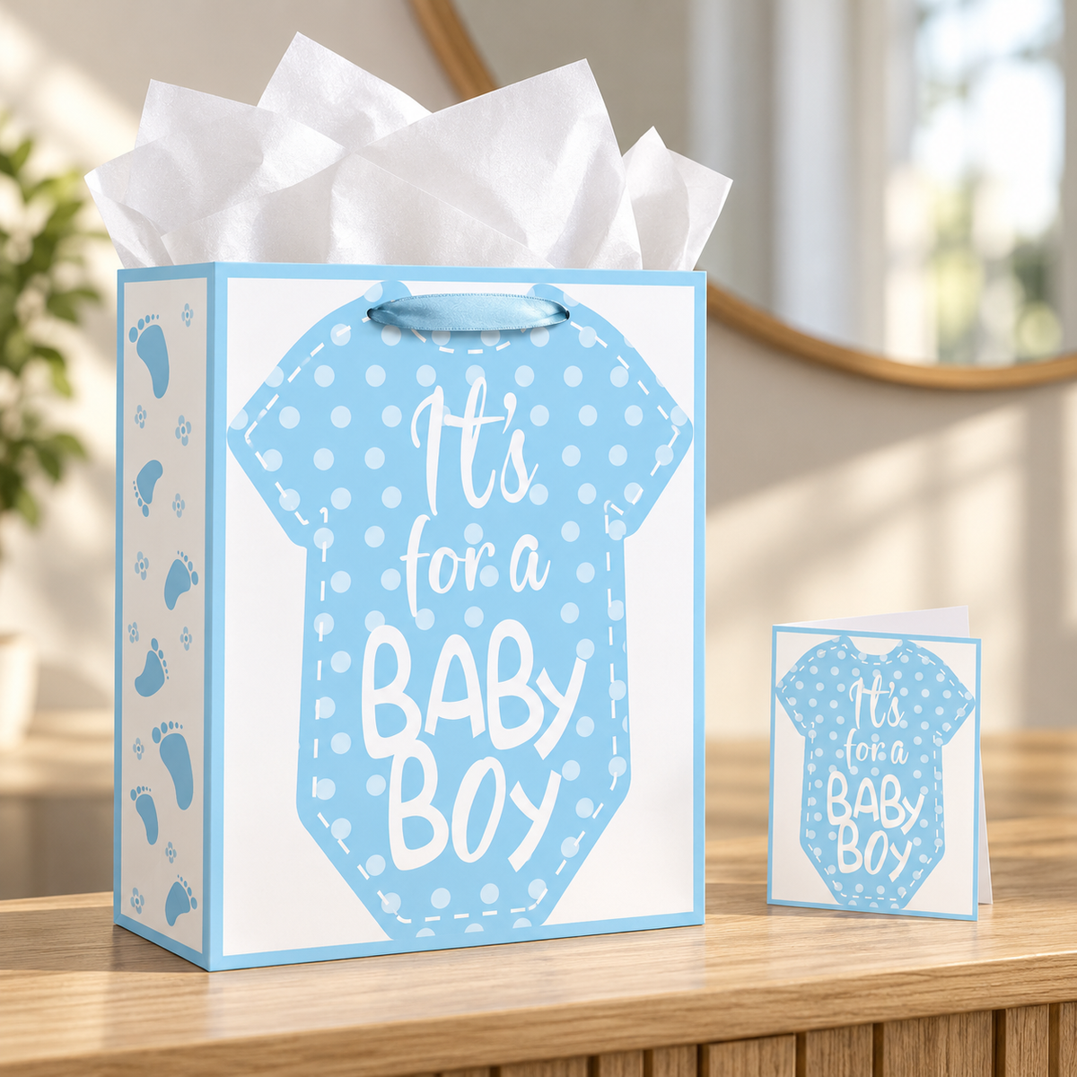 Blue baby shower gift bag with matching card on an entryway console