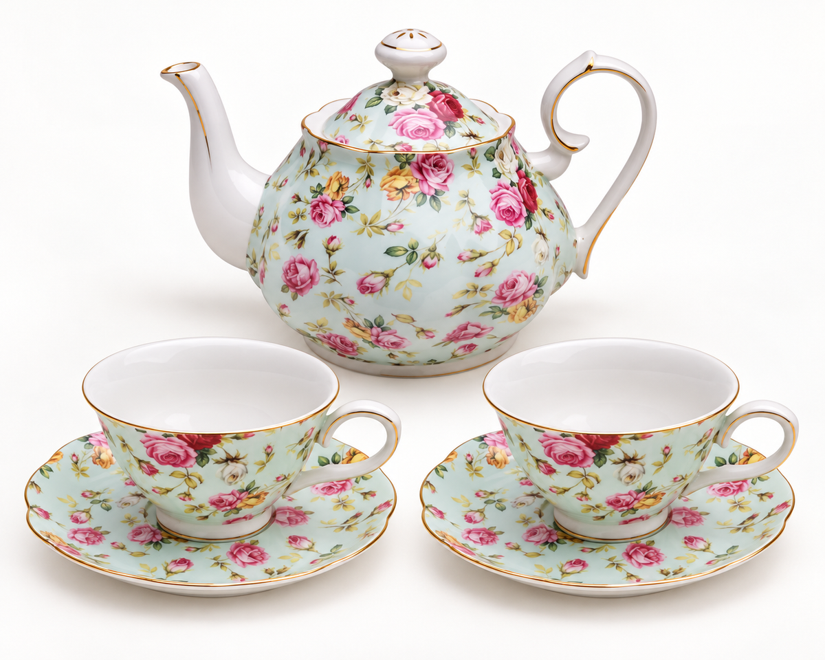 Blue Rose Chintz five-piece teapot, two cups and two saucers on a clean studio background