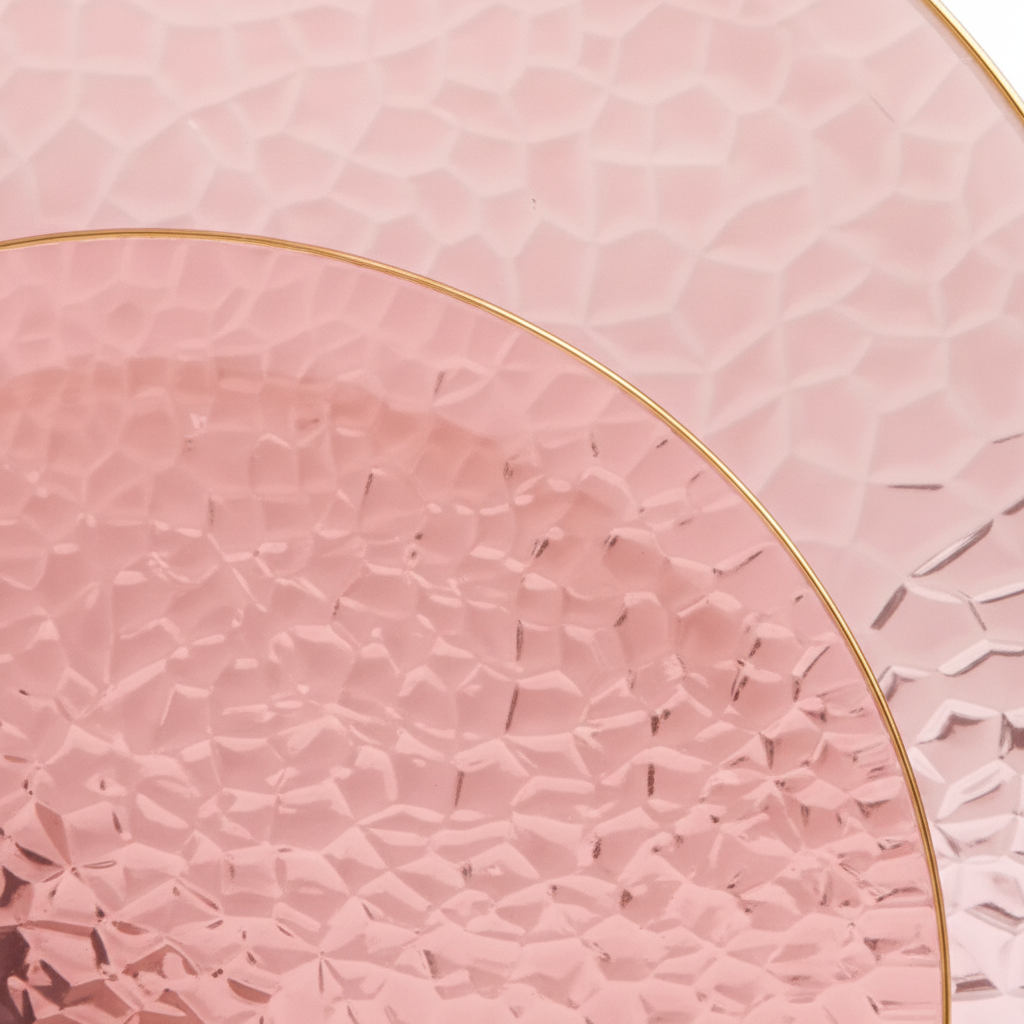 Macro close-up of hammered texture and gold rim on translucent burgundy disposable plastic plate